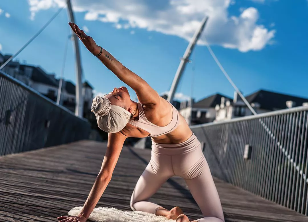 Yoga girl under the blue skies and sunshine posted by YogaPhotographer